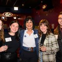 Four alumni standing with President Mantella at the event.